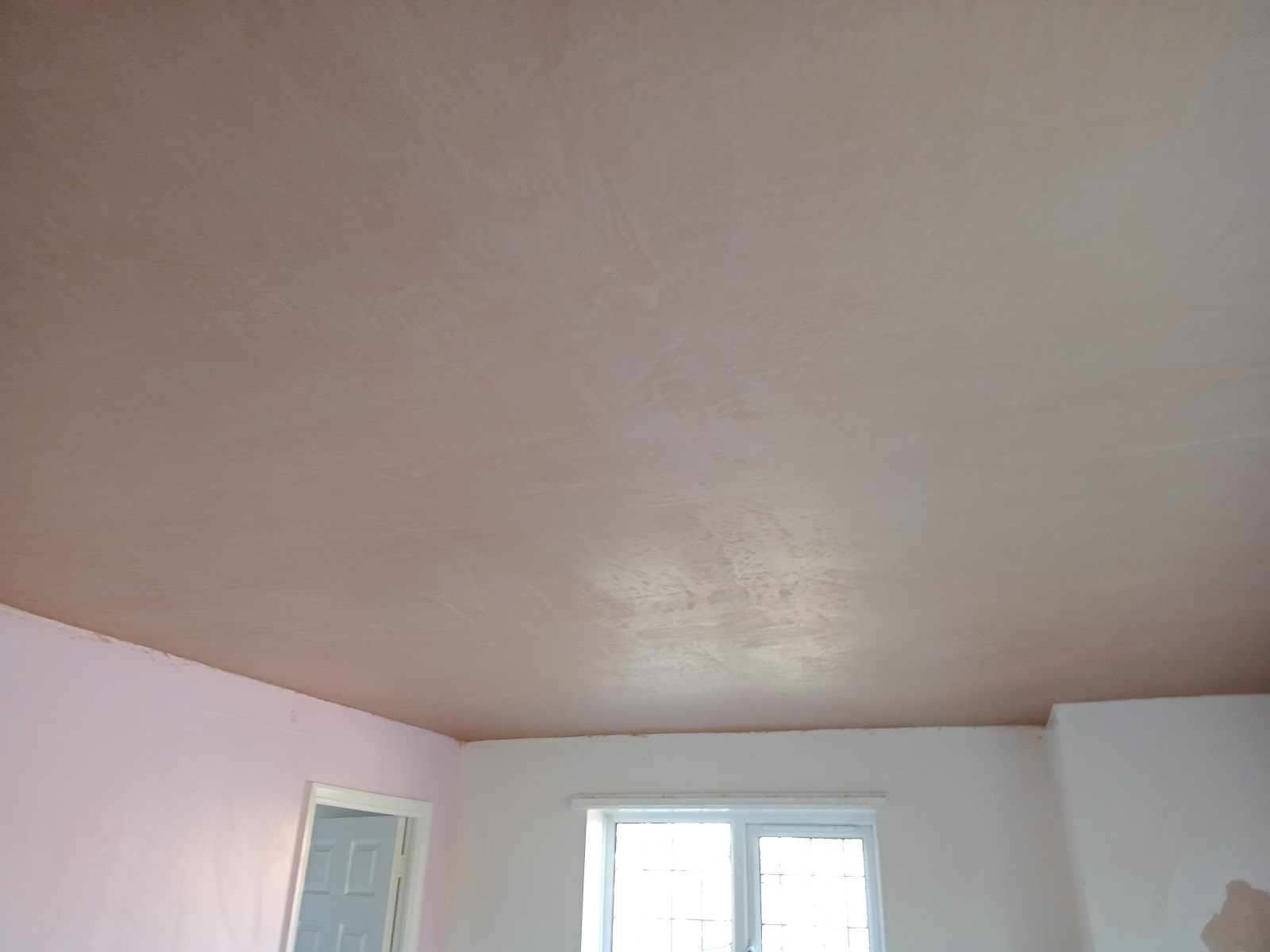 A ceiling freshly skimmed to a smooth finish by Paul Bridges