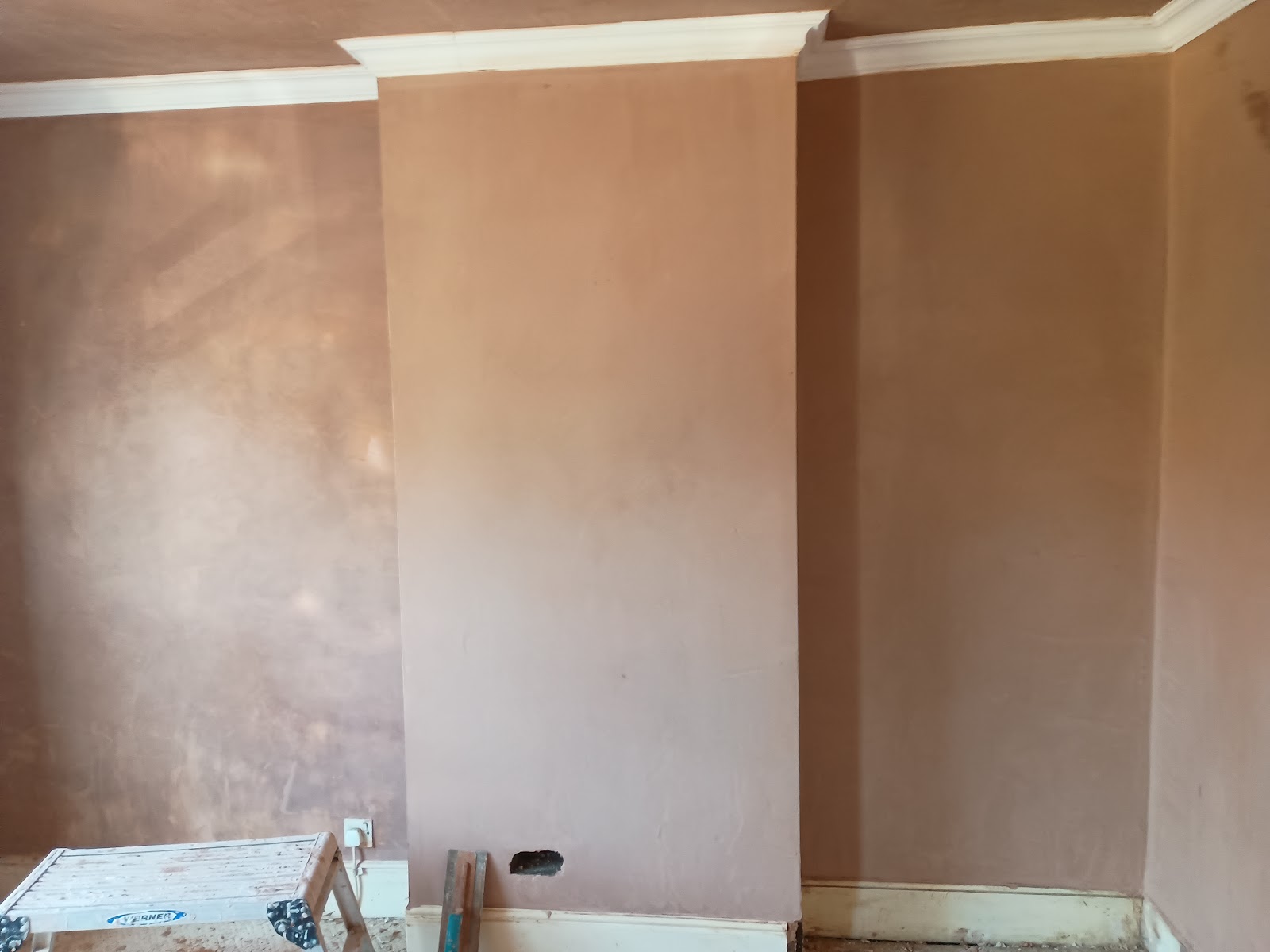 A chimney breast and walls freshly plastered by Paul Bridges, ready for decorating